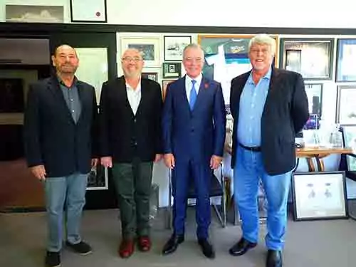 Four men in suits stand together, possibly during a Canberra trip.