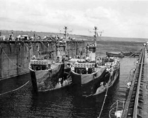 Two ABSD ships, numbered 67 and 219, docked in a dry dock.