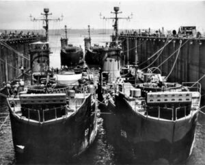 Two ABSD ships in a dry dock, with other ships visible in the background.