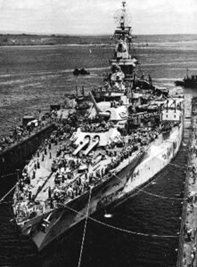 USS Missouri battleship in dry dock, crowds on deck, ABSD historical.