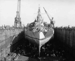 USS 49 in dry dock, Santo Base, with cranes and workers