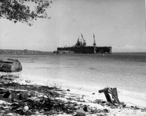 ABSD floating dry dock under construction with cranes in a calm bay