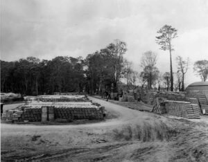 Aore island storage yard with stacks of barrels and pipes, historical site
