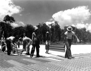 Construction workers building a structure on a sunny day, historical bomber #2 project