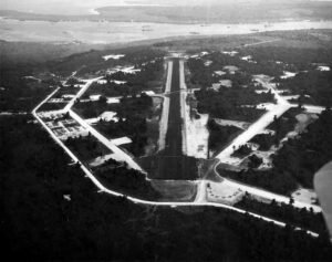 Aerial view of a World War II bomber base runway and facilities.