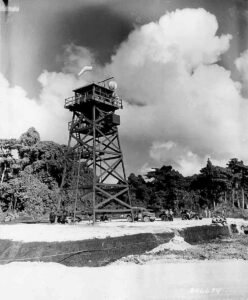 WWII watchtower and vehicles in a jungle setting, possibly related to Bomber #3.