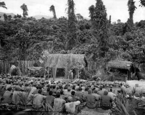 WWII soldiers attend a training session in a jungle clearing, Pacific Theater.