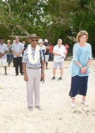 Officials at a museum opening in a tropical setting