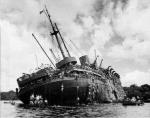 USS Coolidge sinking, survivors cling to the ship and lifeboats