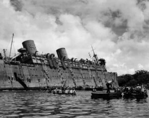SS Coolidge sinking, passengers evacuating into lifeboats during WWII.