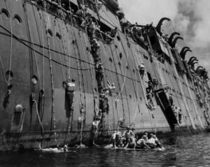 WWII Coolidge survivors climb ropes from life rafts to ship