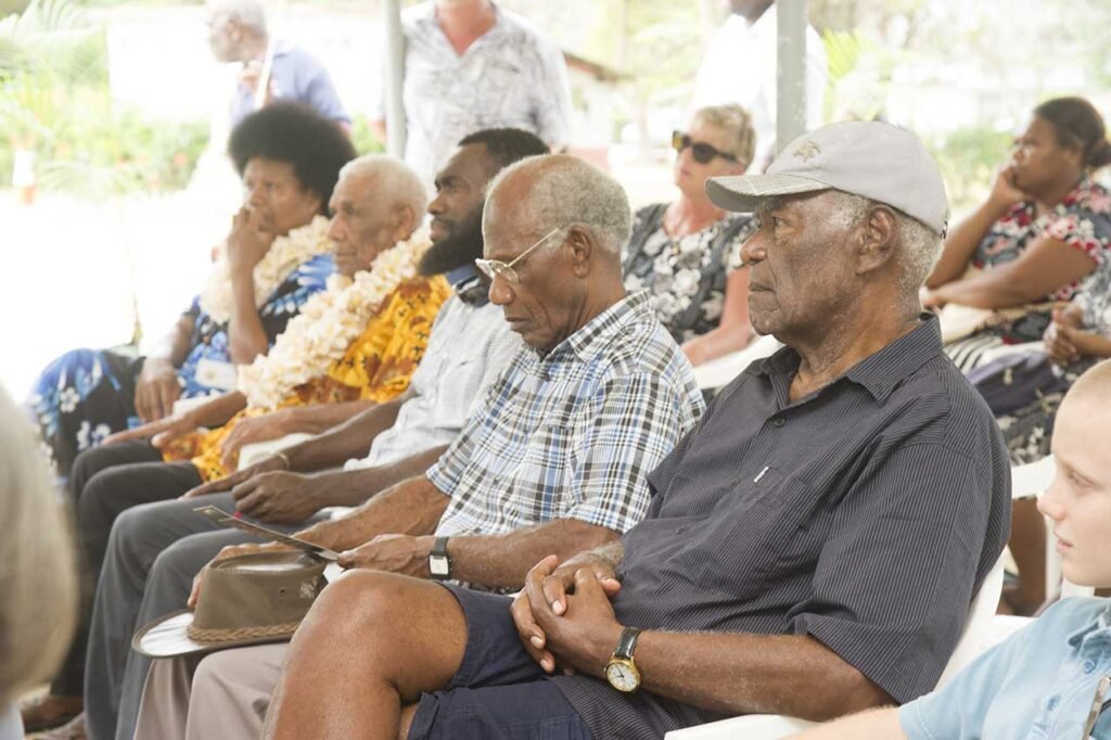 Elders in traditional attire at a museum opening ceremony.
