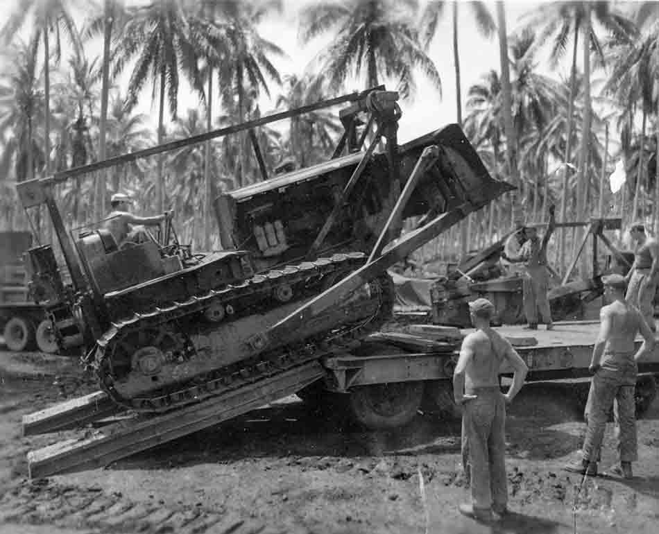 Bulldozers being loaded onto a trailer at Million Dollar Point, Vanuatu.