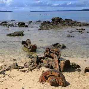 Million Dollar Point: rusted WWII machinery on a sandy beach with the ocean in the background.