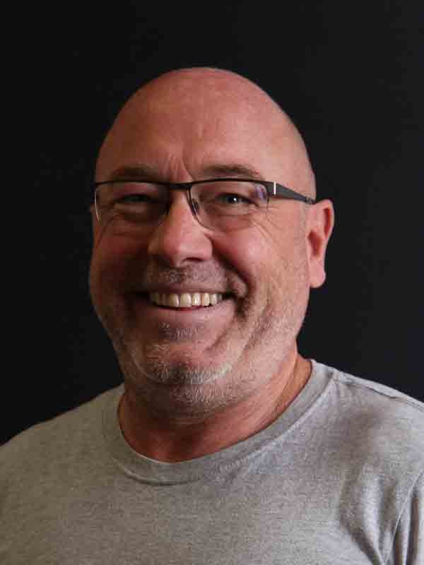 Museum team member, a smiling bald man with glasses