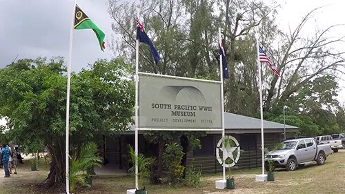 South Pacific WWII Museum entrance with flags and signage