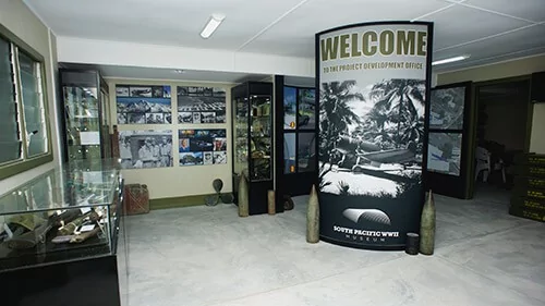 South Pacific WWII Museum interior with "Welcome" banner and artifacts.