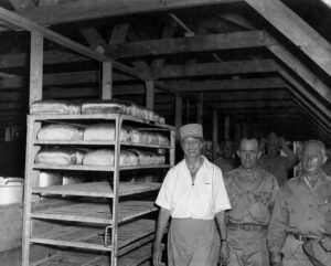 Eleanor Roosevelt with soldiers in a bakery