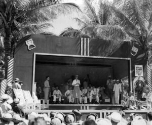 Dixie Band performs on stage under palm trees, historical Roosevelt era.