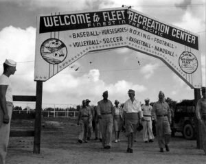 Welcome to Fleet Recreation Center sign with military personnel