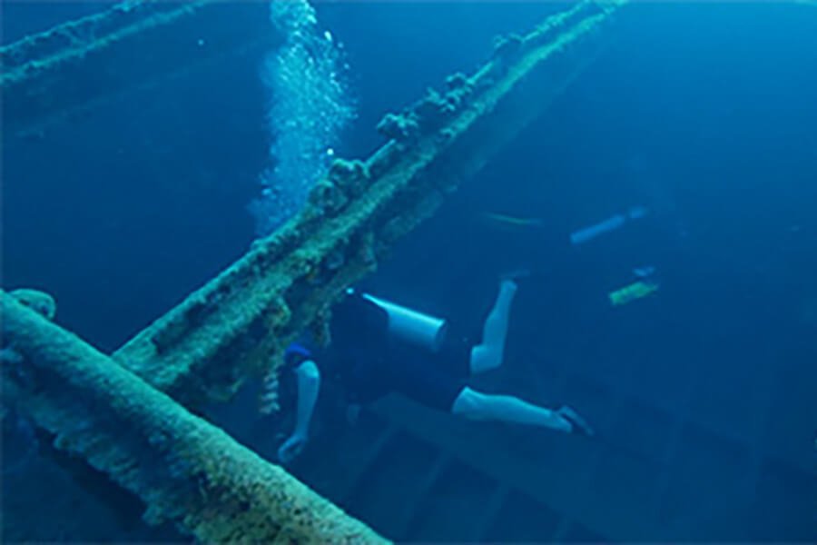Scuba diver exploring a shipwreck, part of a diving gallery