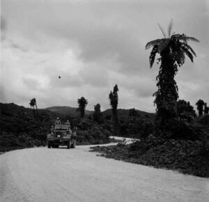 Armored vehicle with soldiers drives on a jungle road, historical vehicles.