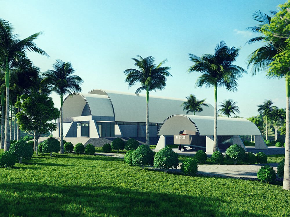 Modern curved building with palm trees and lush green lawn
