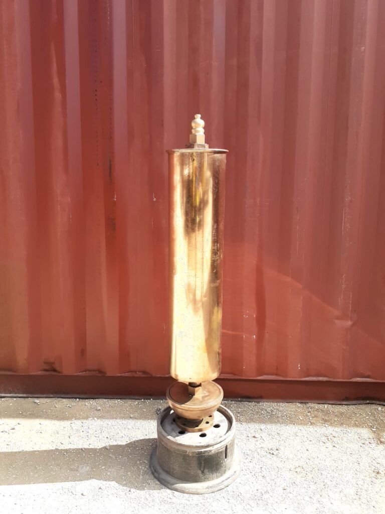 Brass steam whistle on a metal stand, ready to sing.