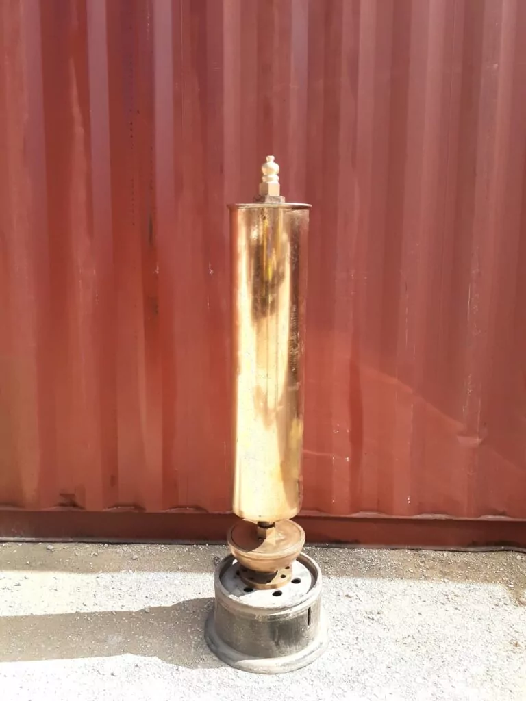 Brass steam whistle on a metal stand, ready to sing.