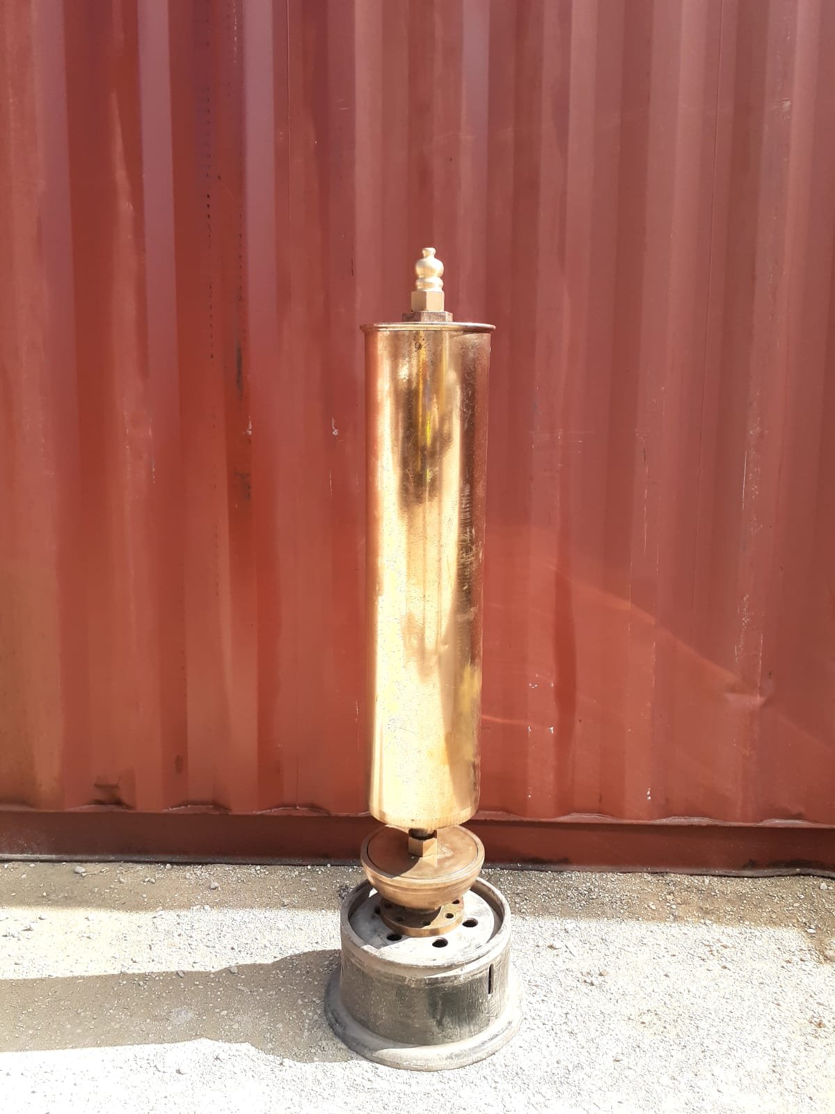 Brass steam whistle on a metal stand, ready to sing.