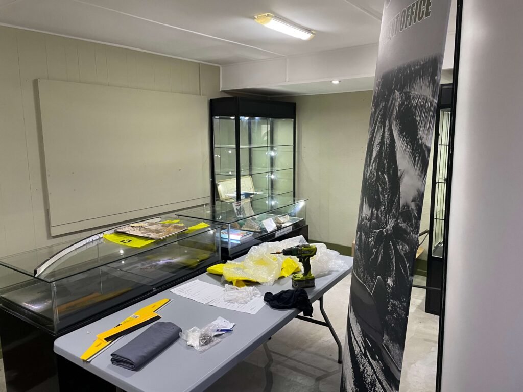 Display cases being set up in a room for old news exhibits.