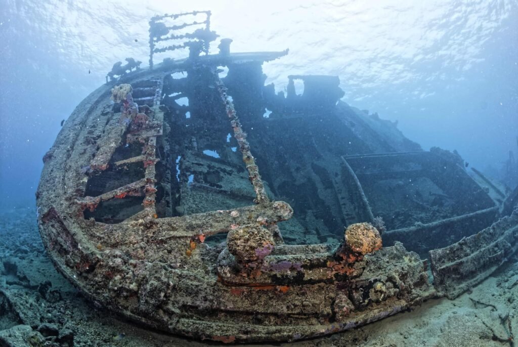 Underwater view of a large, coral-encrusted shipwreck, part of the MDP Gallery.
