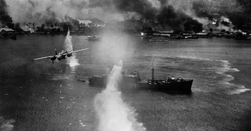WWII aircraft attacks ships in Rabaul harbor during the battle.