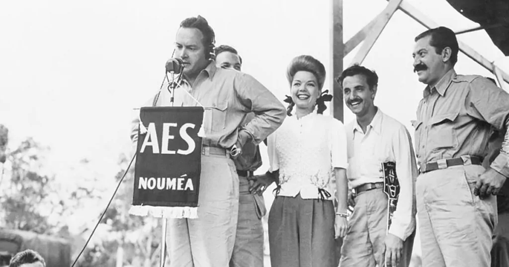 AES Nouméa banner at live broadcast with announcer and performers