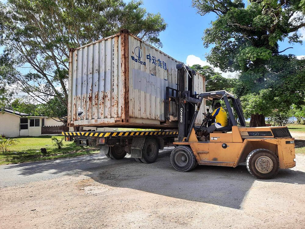 Swire shipping container being unloaded by a Daewoo forklift