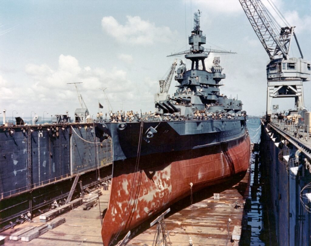 Battleship in a floating dry dock, undergoing maintenance and repairs.