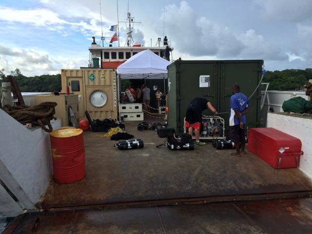 Elwood J Euart crew prepares dive gear on a boat deck.