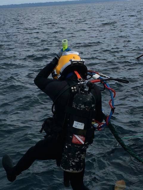 Commercial diver preparing to enter water, Elwood J Euart
