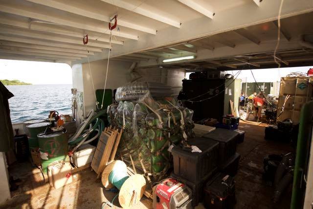 Cargo hold of the Elwood J Euart ship, filled with supplies and equipment
