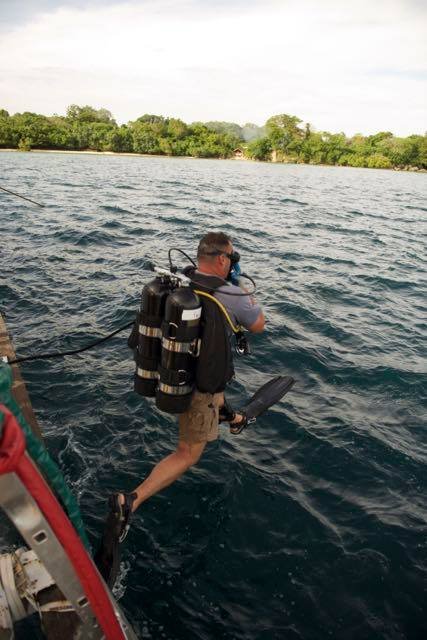 Elwood J Euart prepares to dive into the ocean with scuba gear.