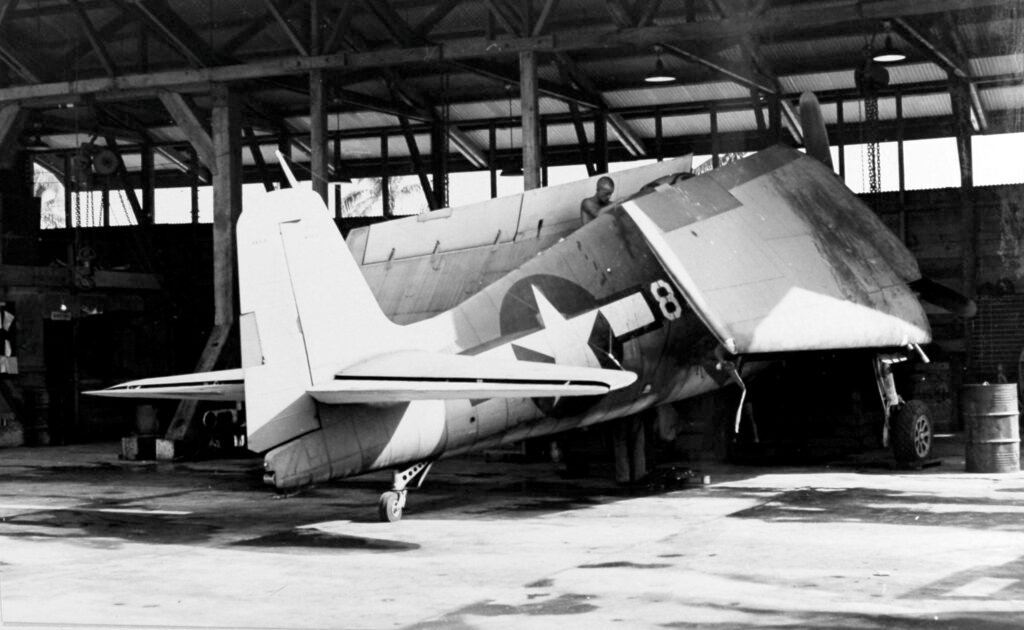 Grumman F4F Wildcat on a damaged airfield, number 8 visible