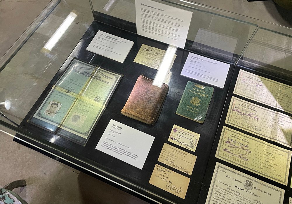 John W. Welch's historical documents, including passports and certificates, displayed in a museum case.