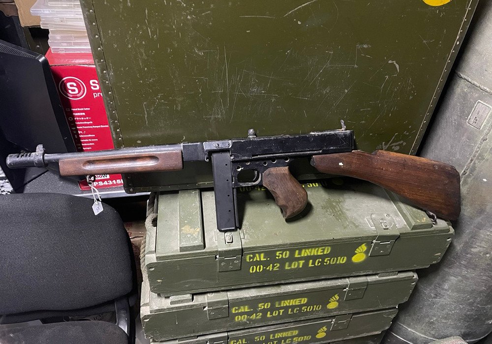 Thompson submachine gun on ammo crates