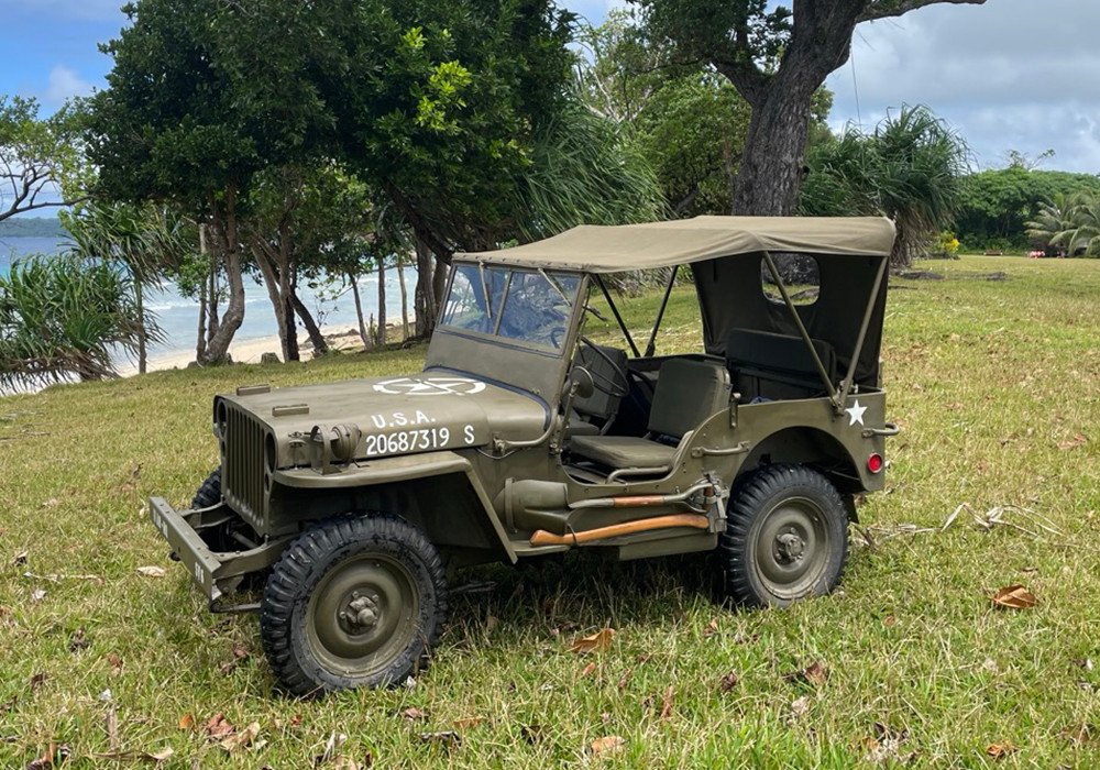 Olive green Willys MB Jeep with "U.S.A. 20687319 S" on the hood