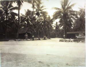 25th Evacuation Hospital entrance with palm trees and a guard