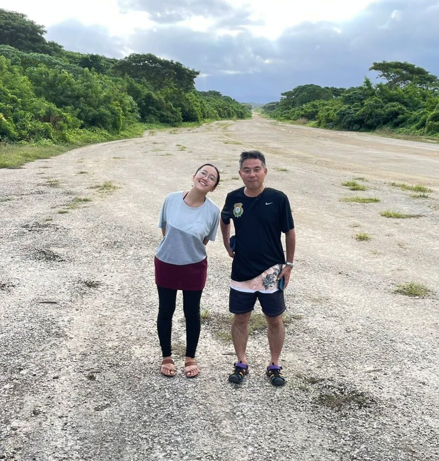 Couple on a deserted airstrip, Guam, part of the Bunkers, Wrecks and Wonders blog.