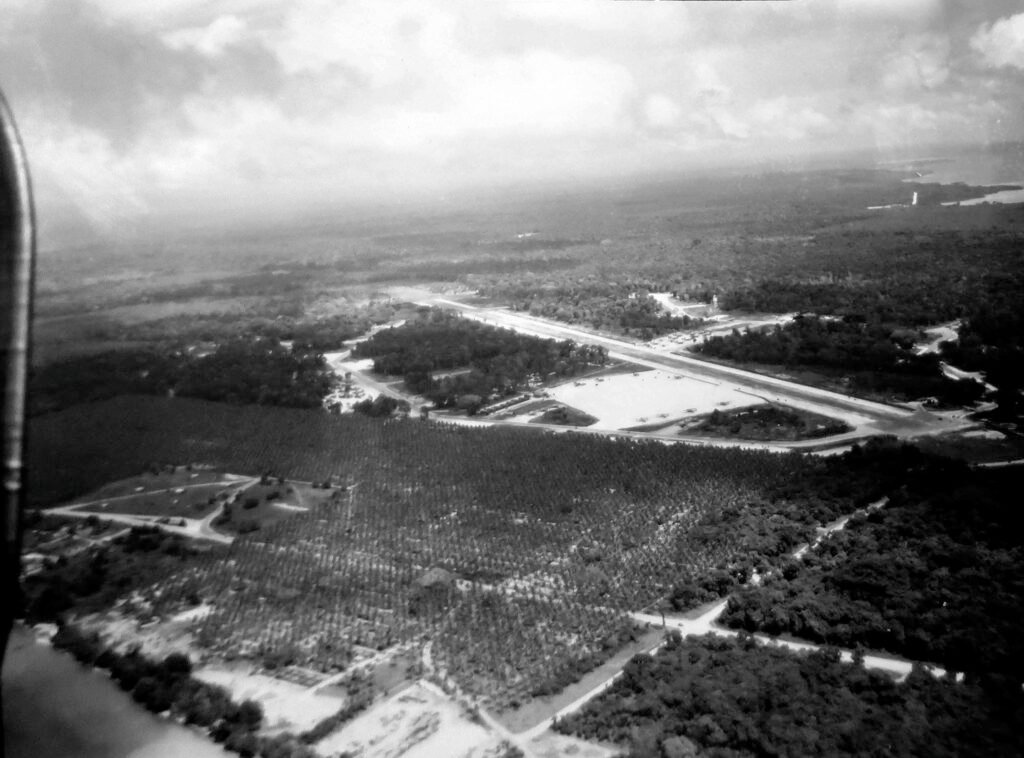 Aerial view of a remote airfield surrounded by lush tropical vegetation.