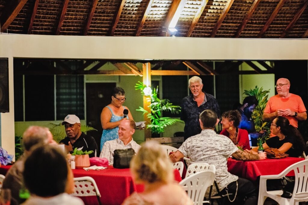 People gathered for a commemoration event at a tropical resort.