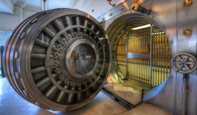 Massive, open bank vault door with gears and a golden interior