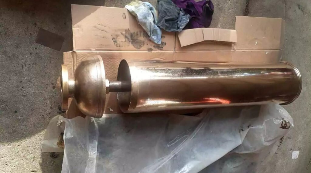 Brass steam whistle components ready for assembly